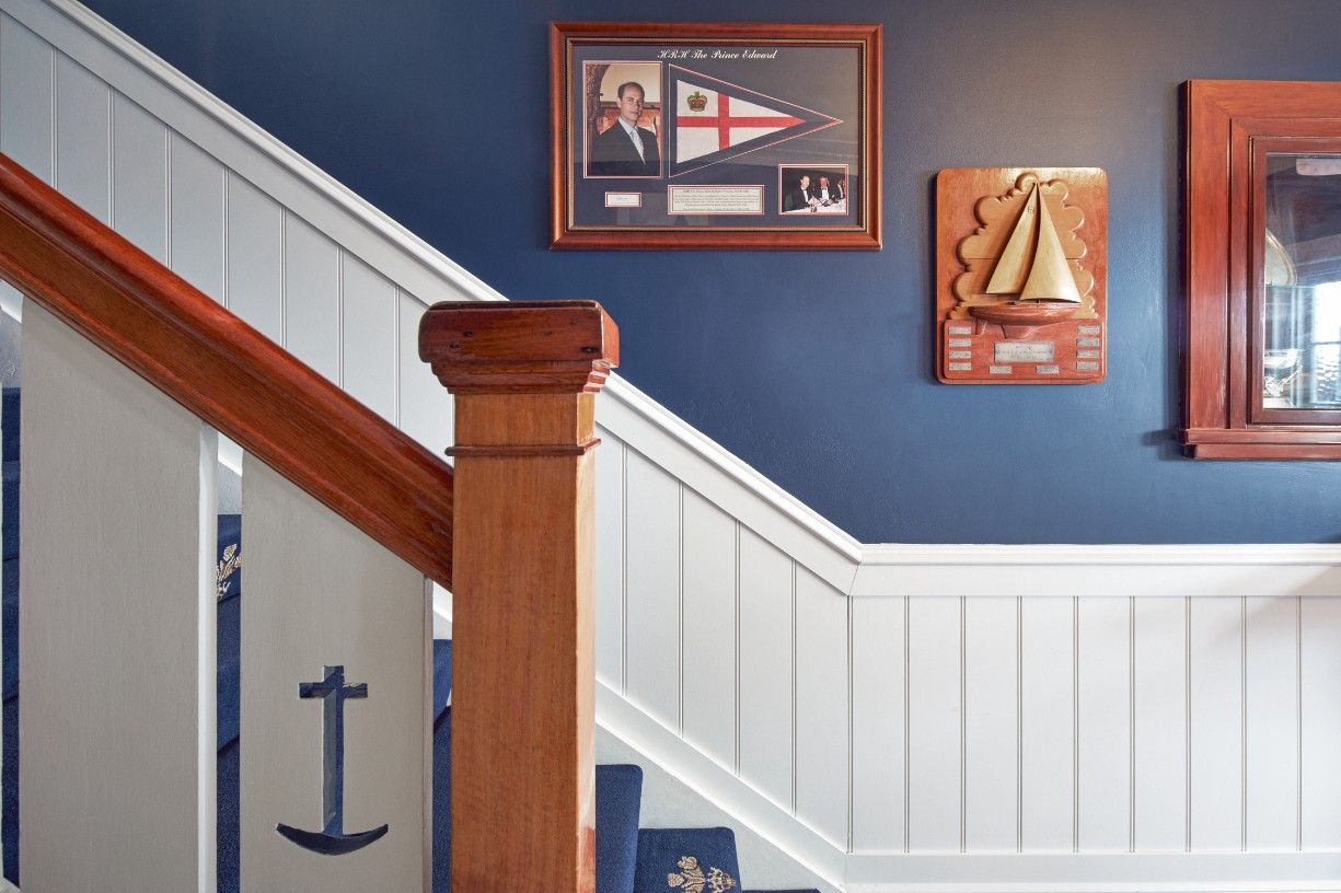 A Staircase With A Picture Of A Sailboat On The Blue Wall — Concept Kitchens In Port Macquarie, NSW