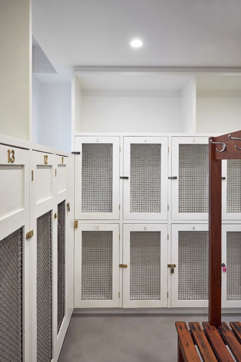 A Locker Room With White Cabinets And Wooden Benches — Concept Kitchens In Port Macquarie, NSW