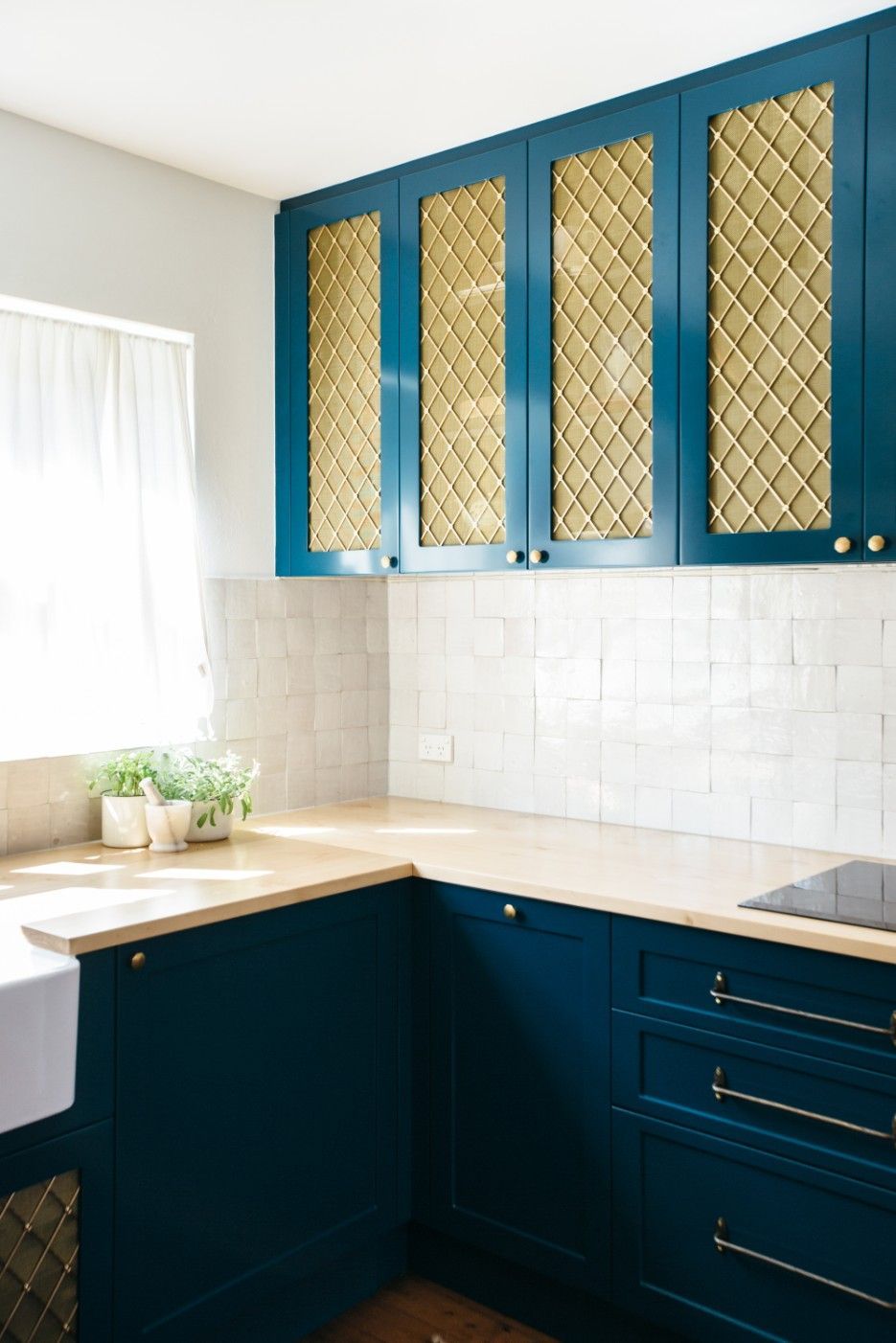 A Kitchen With Gold Blue Cabinets, A Sink, And A Window — Concept Kitchens In Port Macquarie, NSW