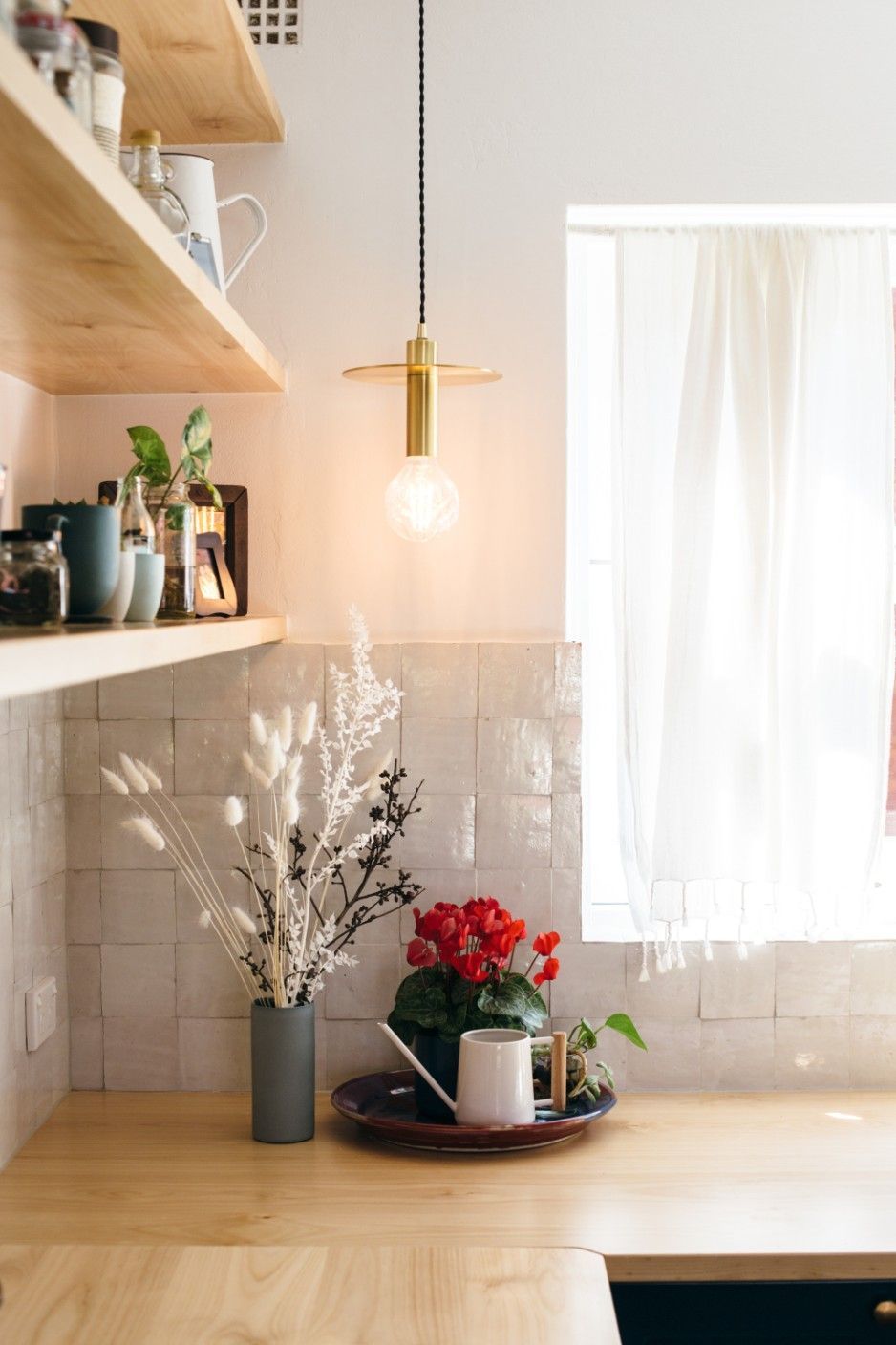 A Kitchen Counter With A Vase Of Flowers And A Watering Can On It — Concept Kitchens In Port Macquarie, NSW