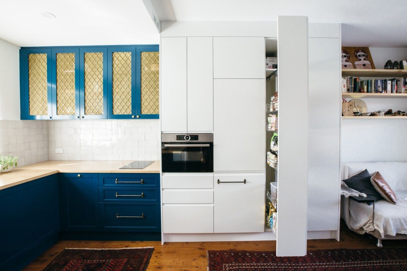 A Kitchen With White Cabinets And A Couch In The Background — Concept Kitchens In Port Macquarie, NSW