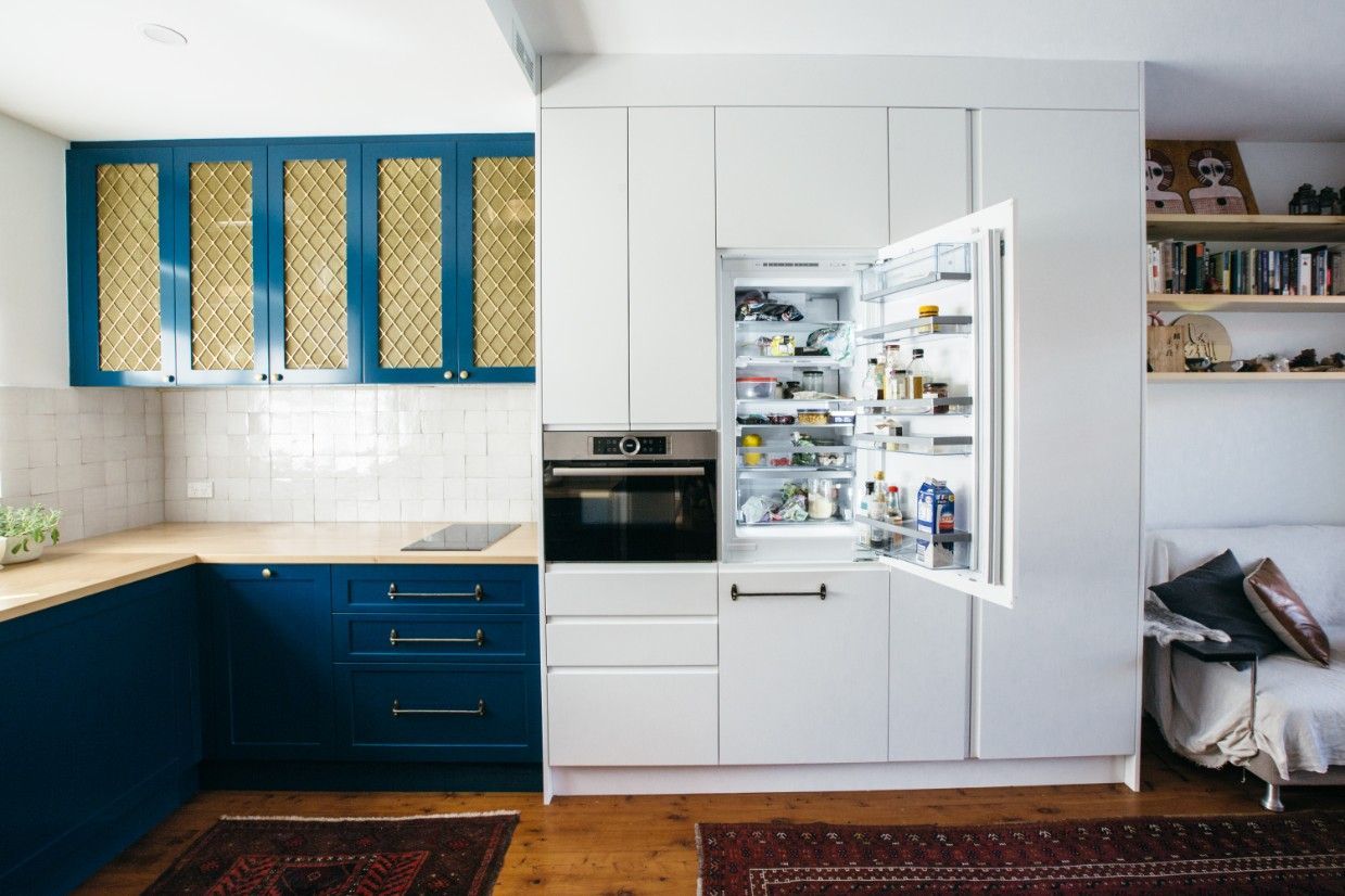 A Kitchen With Blue Cabinets And An Open Refrigerator — Concept Kitchens In Port Macquarie, NSW