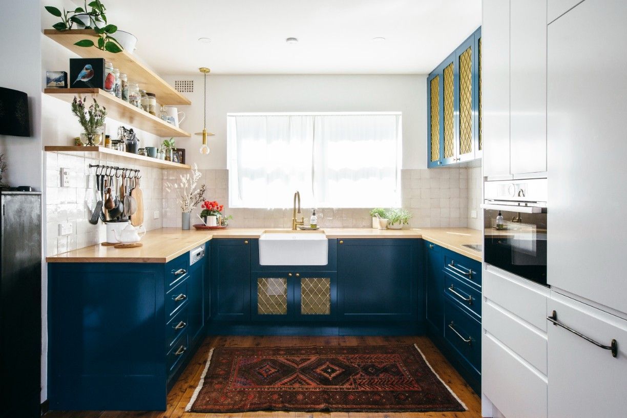 A Kitchen With Dark Blue Cabinets And A Rug On The Floor — Concept Kitchens In Port Macquarie, NSW