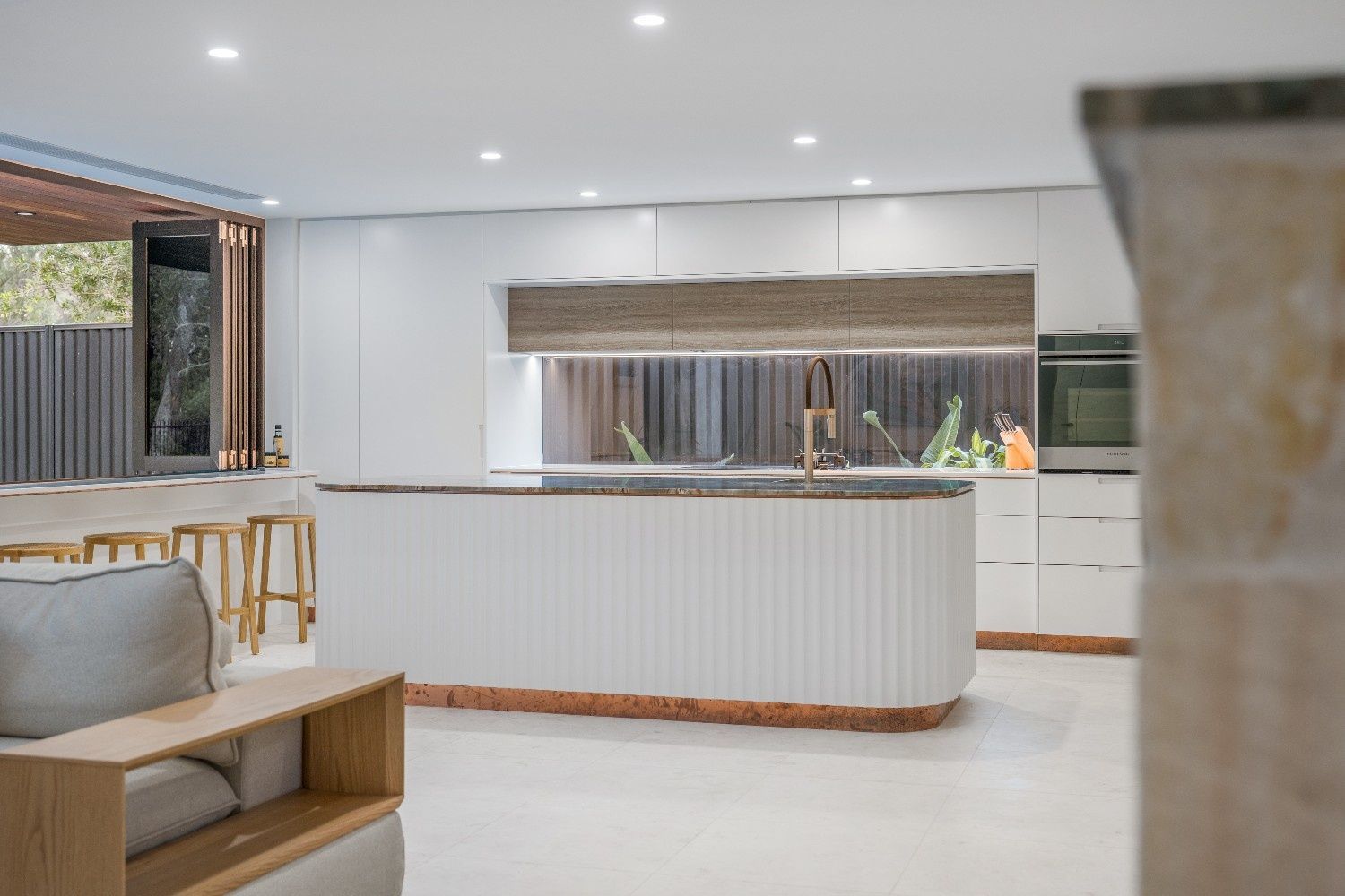 Modern Kitchen with White Cabinets, Curved Island, Copper Trim, and Outdoor View — Concept Kitchens In Port Macquarie, NSW
