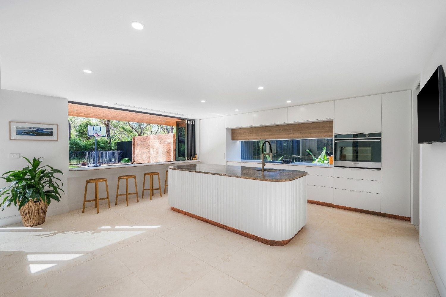 Modern Kitchen with A Large Island, White Cabinets, and A View to A Backyard — Concept Kitchens In Port Macquarie, NSW