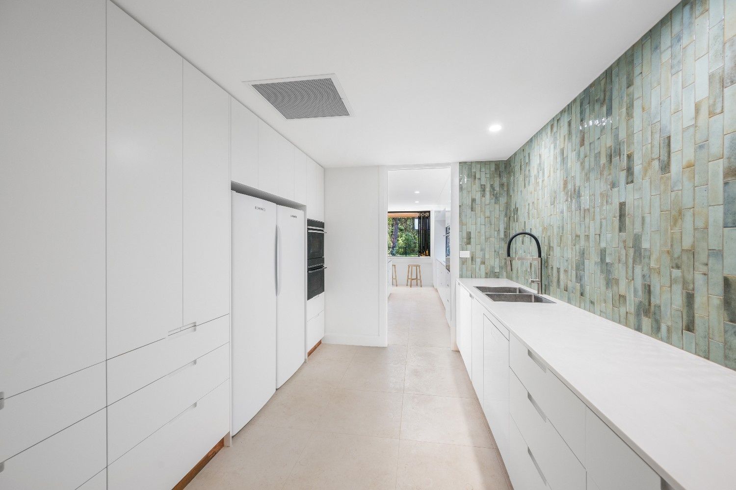 Modern White Kitchen with Textured Green Backsplash, Long Countertop, and Sink — Concept Kitchens In Port Macquarie, NSW