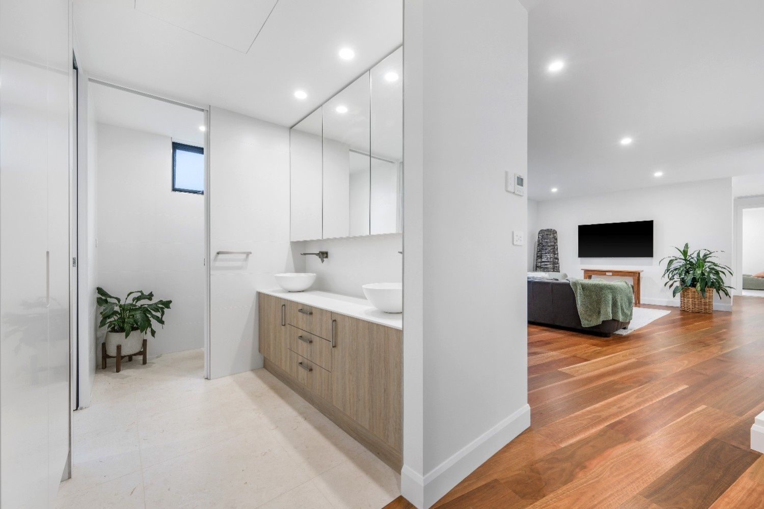 Modern Bathroom with Double Sinks, Light Wood Cabinets, and A View of A Living Room — Concept Kitchens In Port Macquarie, NSW