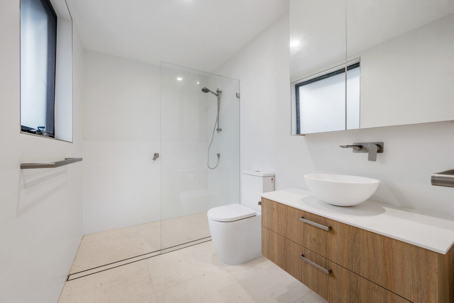 Modern White Bathroom with Wooden Vanity, Glass Shower, and A Window — Concept Kitchens In Port Macquarie, NSW