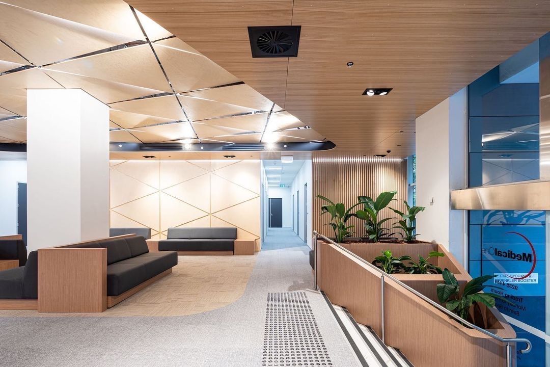 A Well-Lit Hallway With A Couch And Plants In A Building — Concept Kitchens In Port Macquarie, NSW