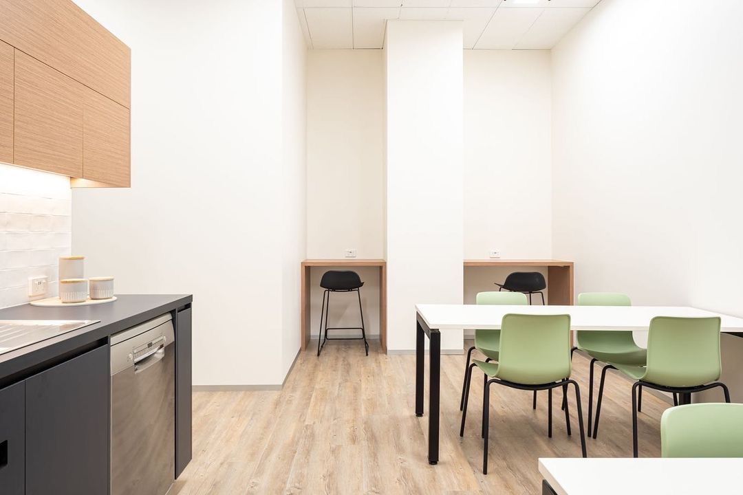 A White Kitchen Hall With A Table And Chairs And A Dishwasher — Concept Kitchens In Port Macquarie, NSW