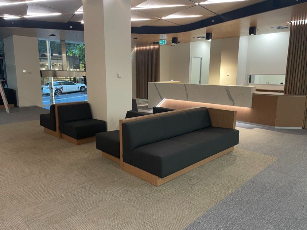 A Waiting Room With A Couch And Dak Green Chairs In It — Concept Kitchens In Port Macquarie, NSW