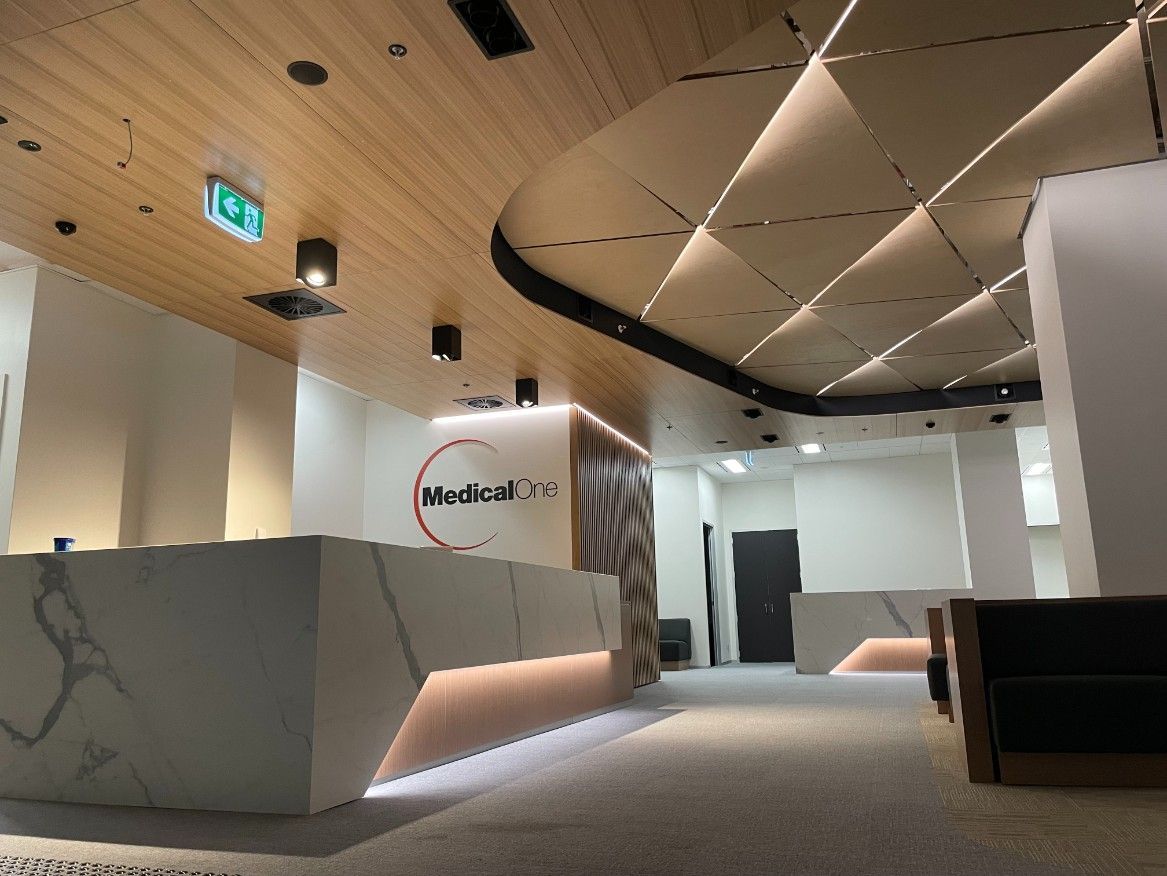 A Hospital Lobby With A Marble Counter And A Brown Wooden Ceiling — Concept Kitchens In Port Macquarie, NSW