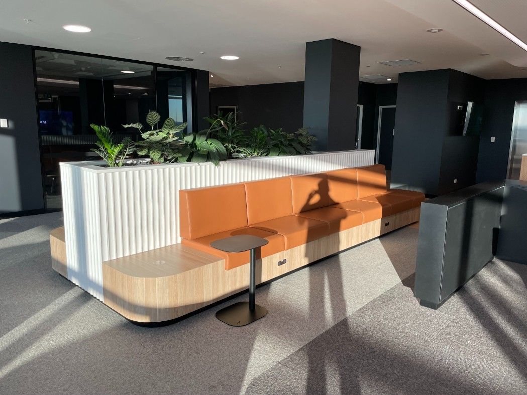 There Is A Brown Couch And A Table In The Middle Of A Room — Concept Kitchens In Port Macquarie, NSW