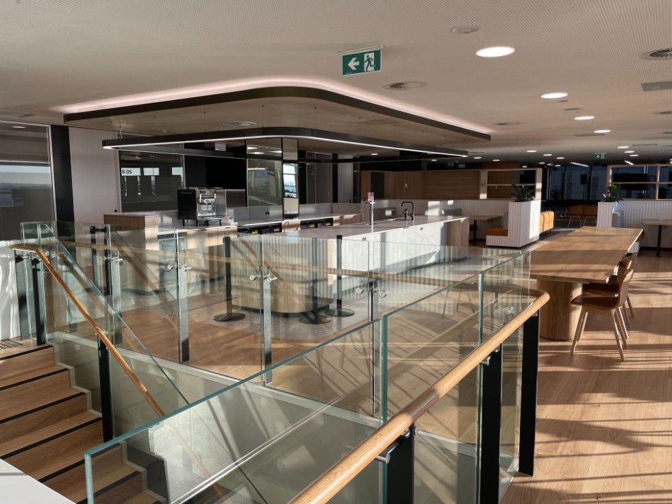 A Large Room With Tables And Lot Chairs And A Glass Railing — Concept Kitchens In Port Macquarie, NSW