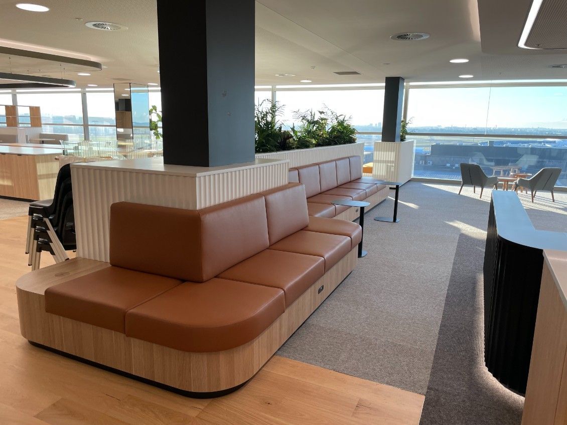 There Is A Long Brown Couch With A Post In The Middle Of The Room — Concept Kitchens In Port Macquarie, NSW