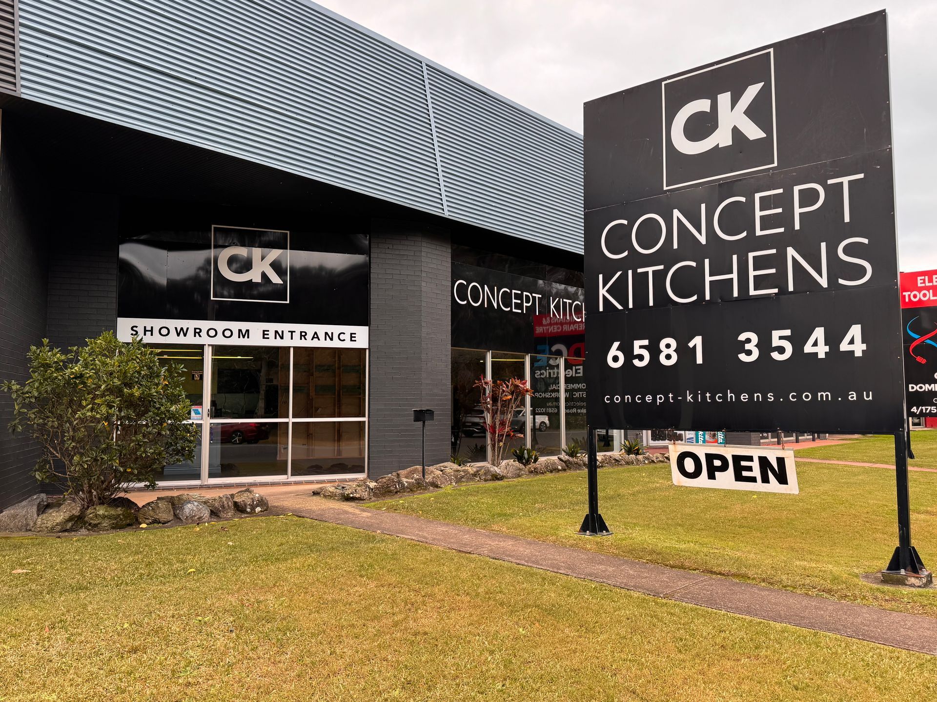 A kitchen with blue cabinets and white counter tops — Concept Kitchens In Port Macquarie, NSW