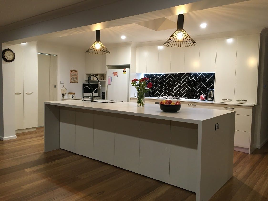 A Kitchen With White Cabinets and a Large Island in the Middle — Concept Kitchens In Port Macquarie, NSW