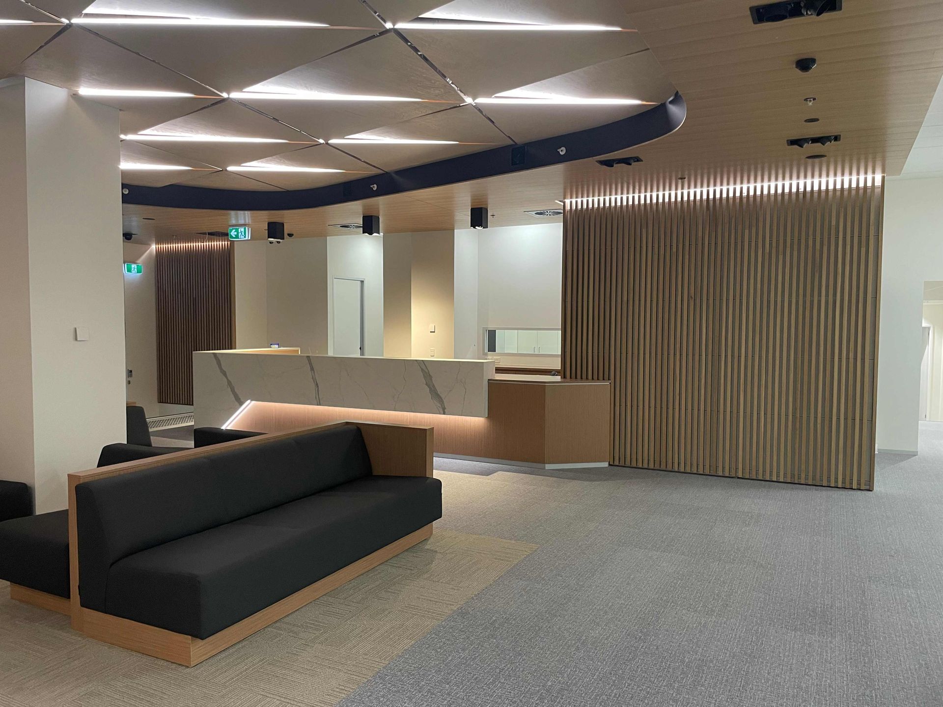 A Modern, Minimalist Waiting Area With A Sleek Reception Desk And Comfortable Seating — Concept Kitchens In Port Macquarie, NSW