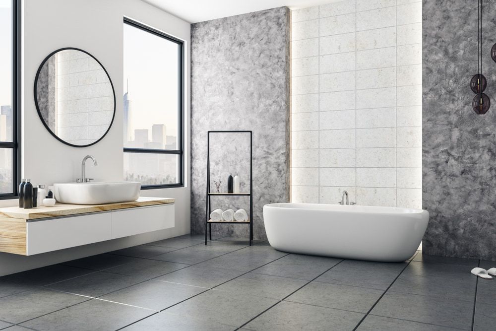 A Bathroom with A Bathtub , Sink , Mirror and Window — Mid Coast Tile Co in Taree, NSW