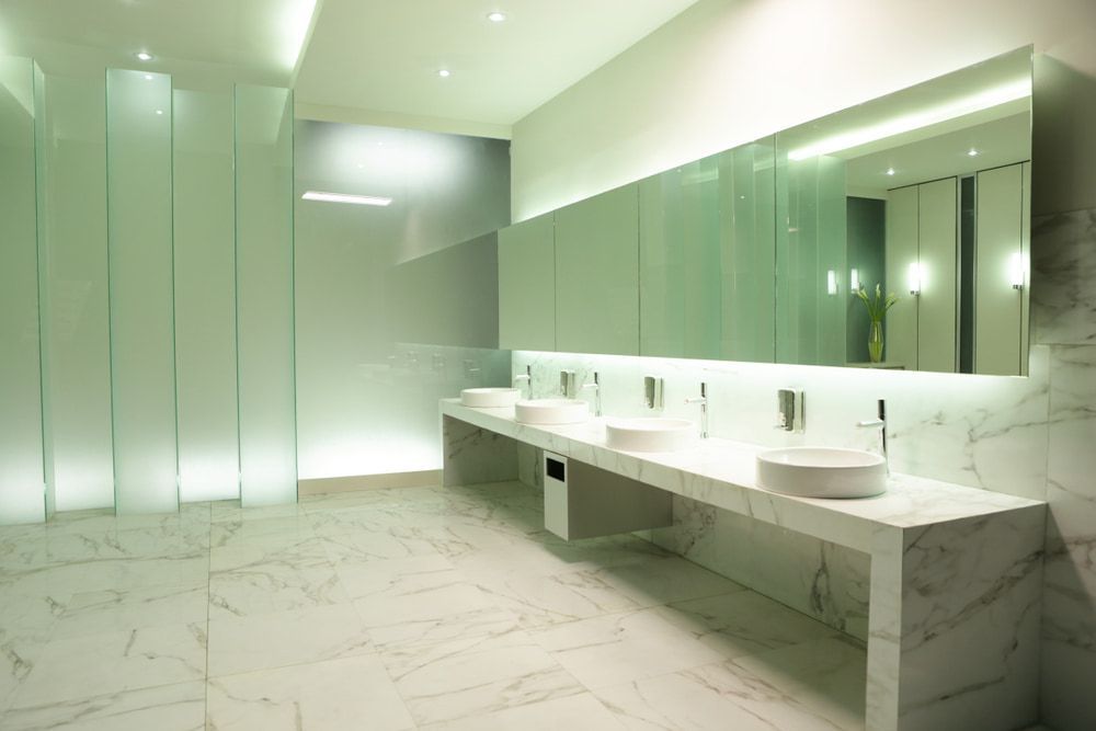 A Bathroom with A Row of Sinks and A Large Mirror — Mid Coast Tile Co in Taree, NSW