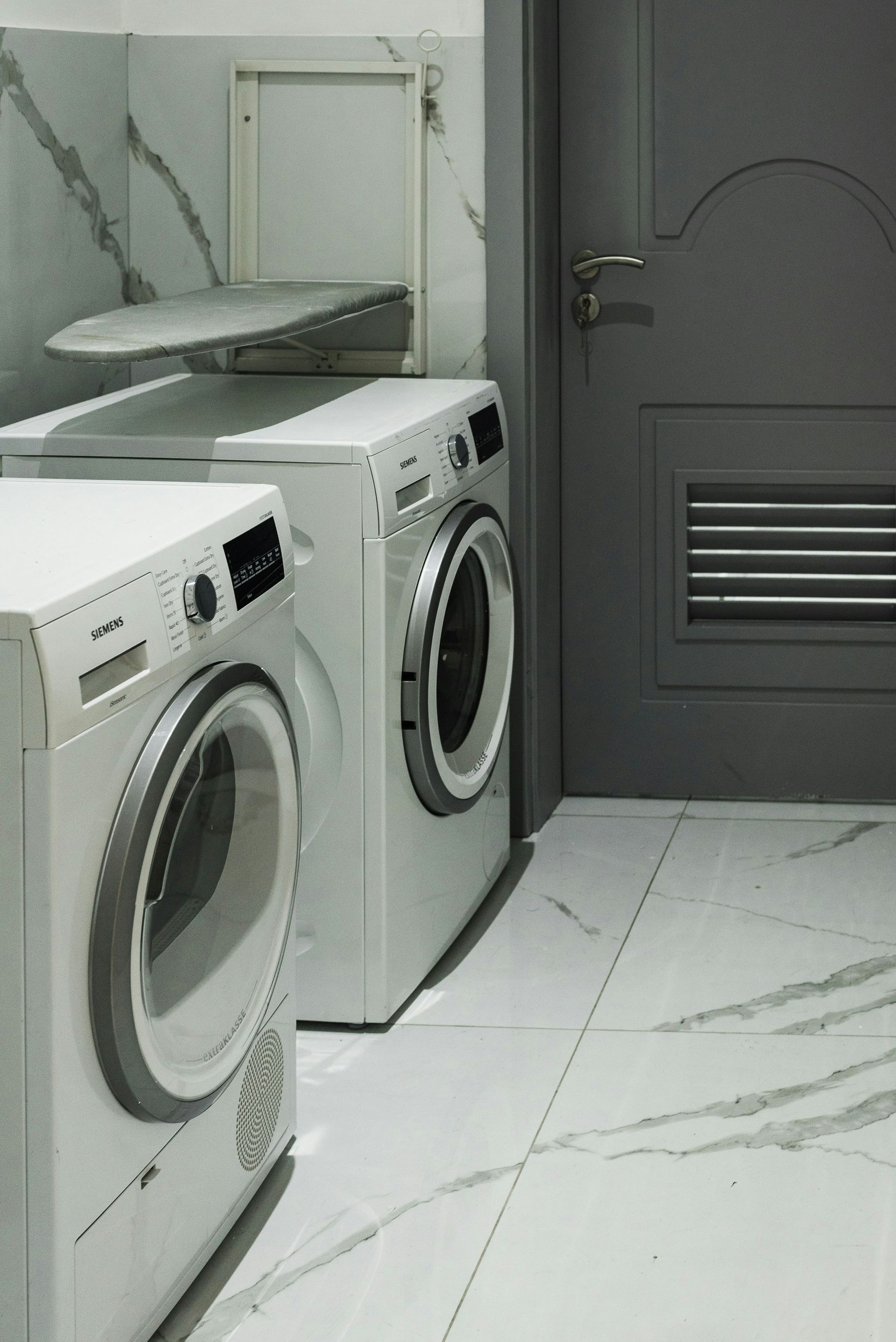 A Laundry Room with Two Washing Machines and A Sink — Mid Coast Tile Co in Taree, NSW