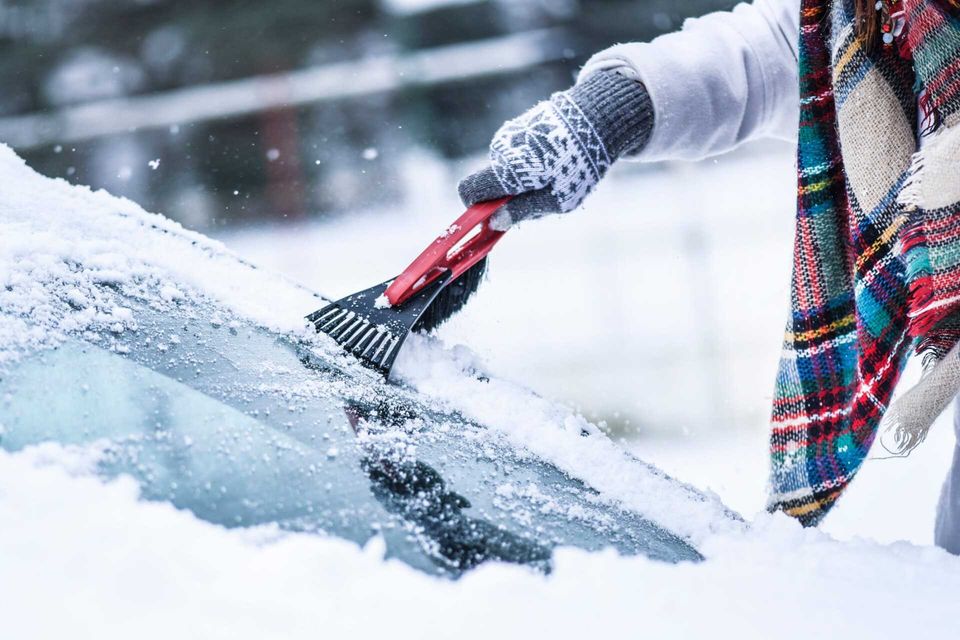 Woman Cleaning Snow From Windshield — Gainesville, FL — Automotive Super Sports