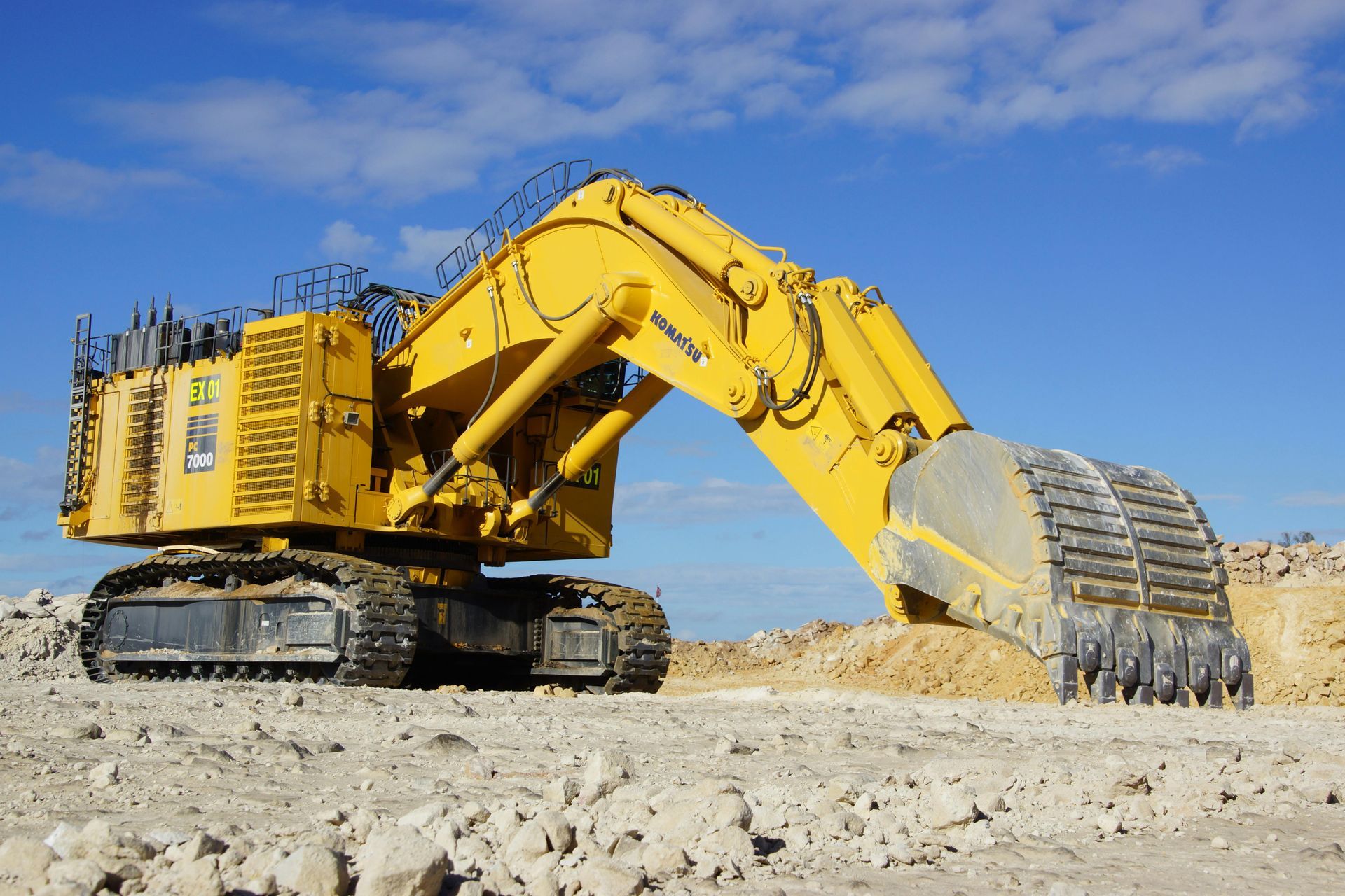 A large yellow excavator with the word komatsu on it