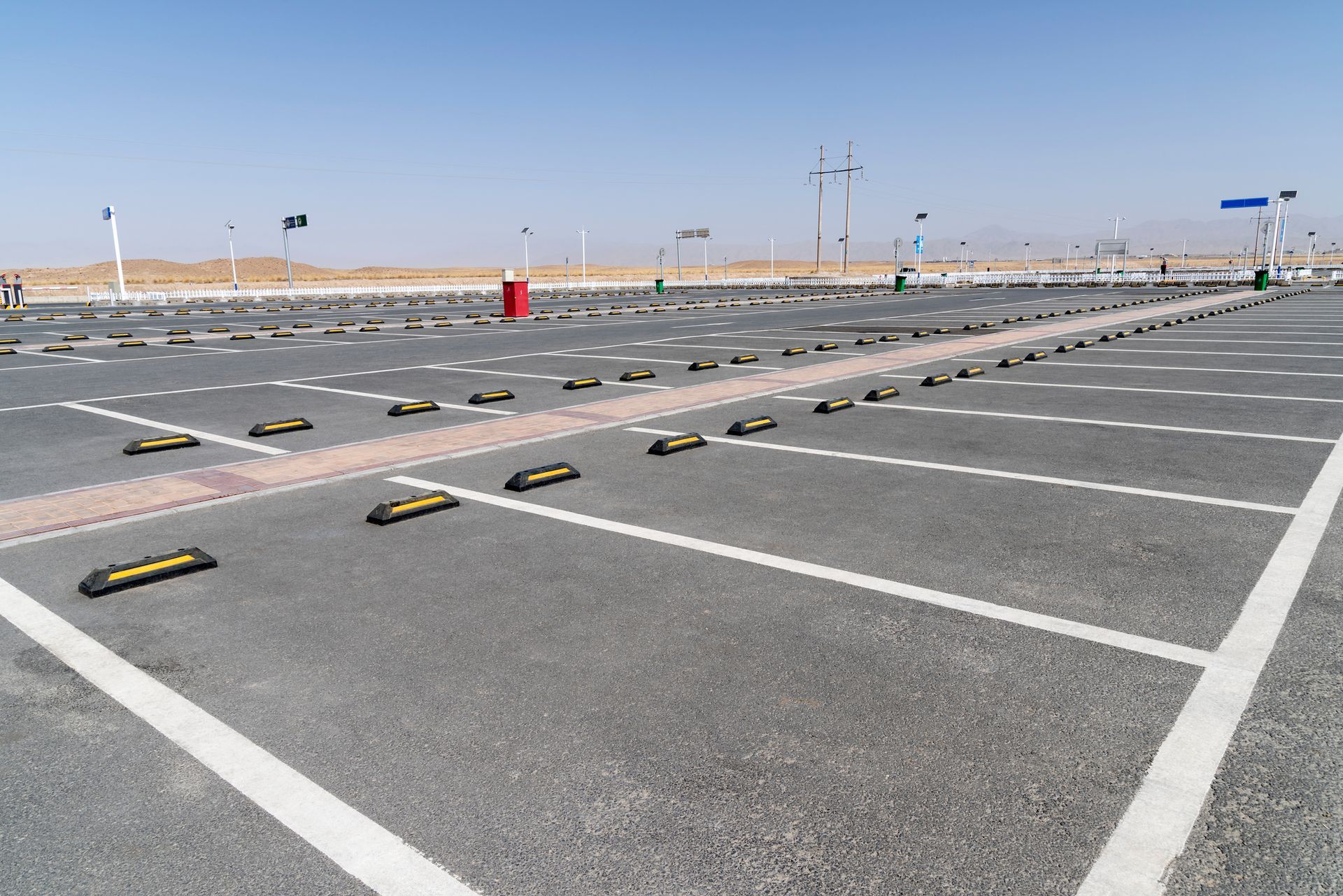 An empty parking lot with yellow and white lines
