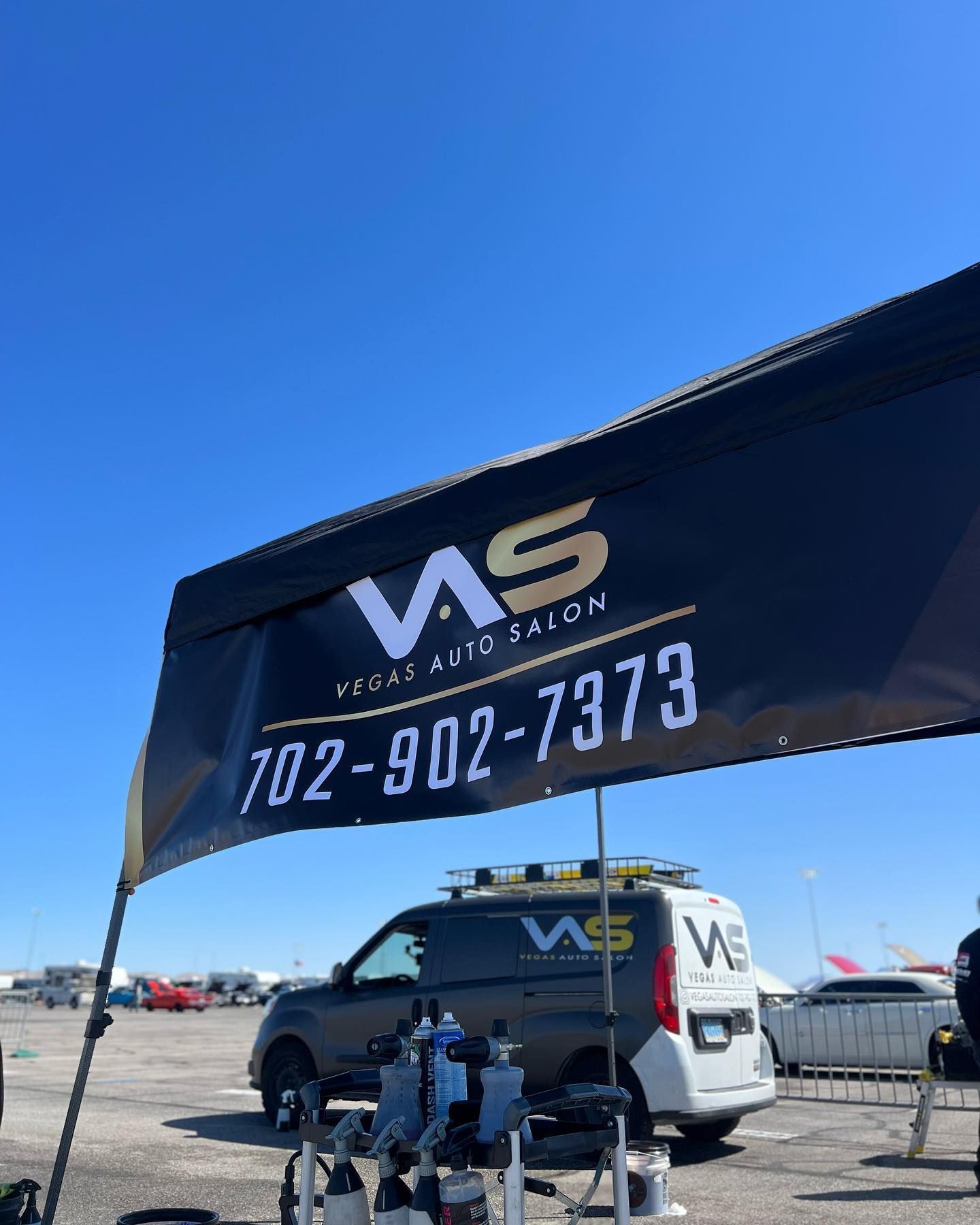 A van is parked under an awning that says ws