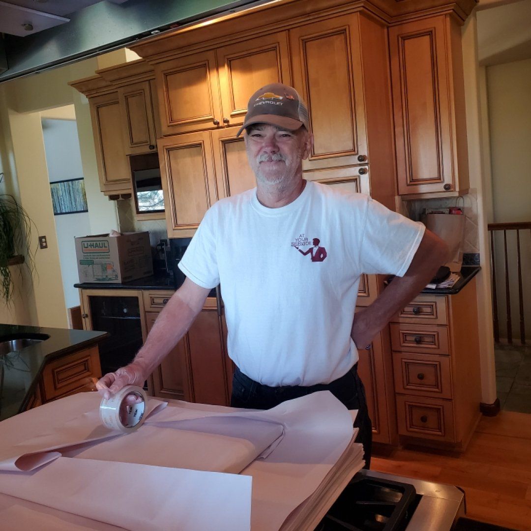 A Team Member Holding His Materials — Aurora, CO — At Your Service Moving and Storage