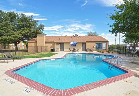 Swimming pool in front of a tan building with brown roof under a partly cloudy blue sky. Ready to make Southgate Apartment Homes in Odessa, TX your home? Contact us today for more information about our pet-friendly 1, 2, and 3-bedroom apartment homes. Our community offers all the comfort and conveniences you’ll need and a prime location. We can’t wait to welcome you home!