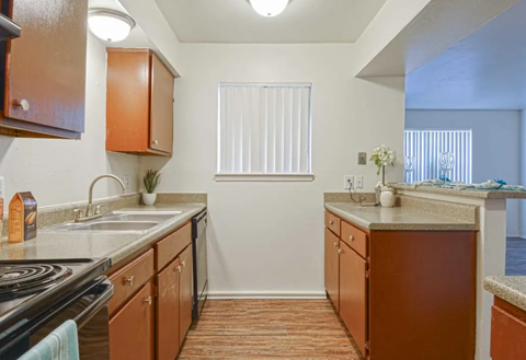 Kitchen with brown cabinets, a stainless steel sink, and a window with blinds. Ready to make Southgate Apartment Homes in Odessa, TX your home? Contact us today for more information about our pet-friendly 1, 2, and 3-bedroom apartment homes. Our community offers all the comfort and conveniences you’ll need and a prime location. We can’t wait to welcome you home!