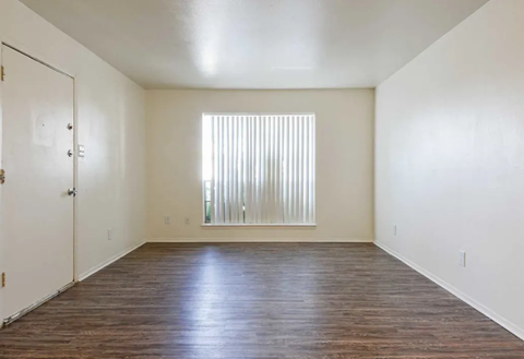 Empty room with dark wood flooring, white walls, and a window with blinds. Ready to make Southgate Apartment Homes in Odessa, TX your home? Contact us today for more information about our pet-friendly 1, 2, and 3-bedroom apartment homes. Our community offers all the comfort and conveniences you’ll need and a prime location. We can’t wait to welcome you home!
