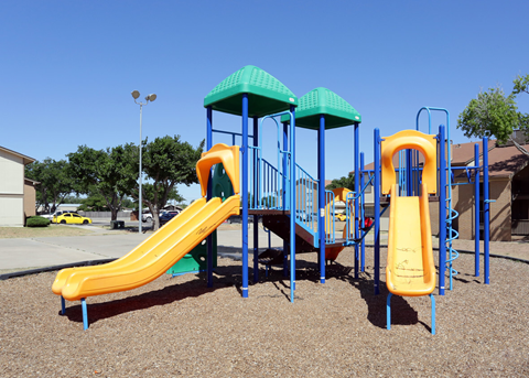 Playground with two yellow slides, blue frame, green roof, set on wood chips, under a blue sky. Ready to make Southgate Apartment Homes in Odessa, TX your home? Contact us today for more information about our pet-friendly 1, 2, and 3-bedroom apartment homes. Our community offers all the comfort and conveniences you’ll need and a prime location. We can’t wait to welcome you home!