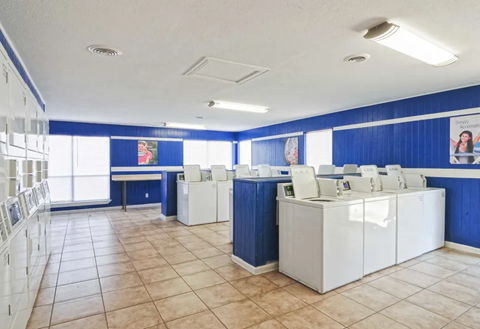 Laundry room with white appliances and blue walls, lockers, and tiled floor. Ready to make Southgate Apartment Homes in Odessa, TX your home? Contact us today for more information about our pet-friendly 1, 2, and 3-bedroom apartment homes. Our community offers all the comfort and conveniences you’ll need and a prime location. We can’t wait to welcome you home!