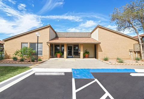 Building exterior with accessible parking spot. Tan brick building with blue sky. Ready to make Southgate Apartment Homes in Odessa, TX your home? Contact us today for more information about our pet-friendly 1, 2, and 3-bedroom apartment homes. Our community offers all the comfort and conveniences you’ll need and a prime location. We can’t wait to welcome you home!