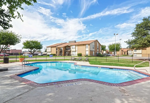 Apartment complex with a blue swimming pool, green grass, and sunny sky. Ready to make Southgate Apartment Homes in Odessa, TX your home? Contact us today for more information about our pet-friendly 1, 2, and 3-bedroom apartment homes. Our community offers all the comfort and conveniences you’ll need and a prime location. We can’t wait to welcome you home!