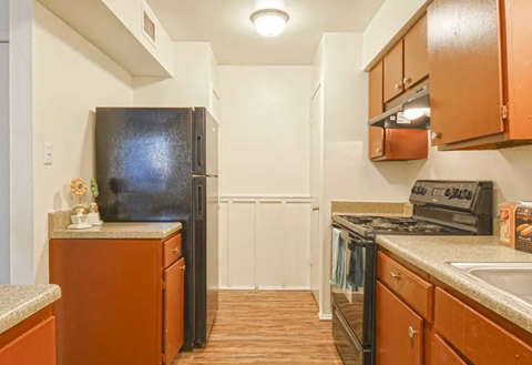 Kitchen with brown cabinets, black appliances, and neutral-colored walls and countertops. Ready to make Southgate Apartment Homes in Odessa, TX your home? Contact us today for more information about our pet-friendly 1, 2, and 3-bedroom apartment homes. Our community offers all the comfort and conveniences you’ll need and a prime location. We can’t wait to welcome you home!