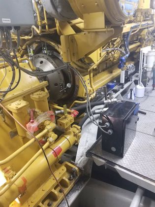 A large yellow engine is sitting on top of a table.