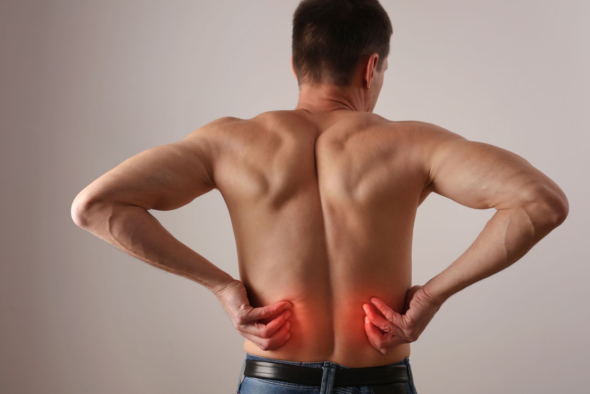 Man holding lower back with red pain highlights, showing back pain discomfort