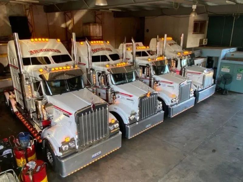 several trucks lined up in a row in a parking lot