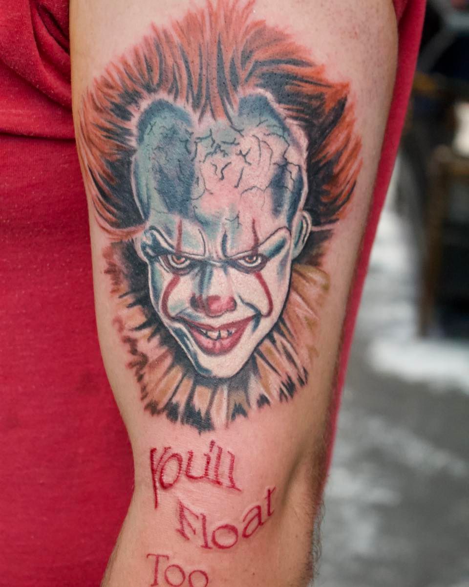 A tattoo of a clown with the words you 'll float too