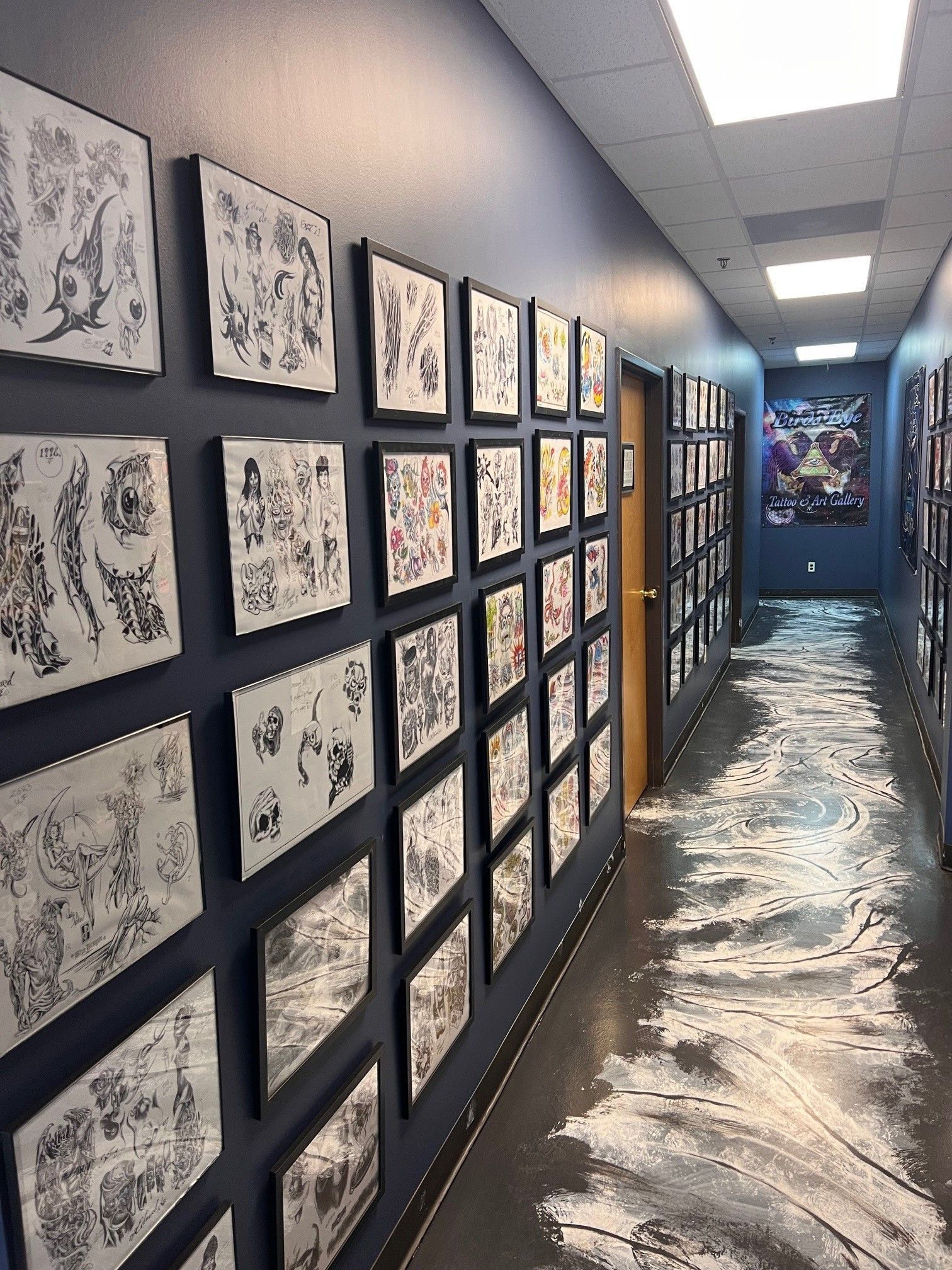 A long hallway with a lot of pictures on the wall.