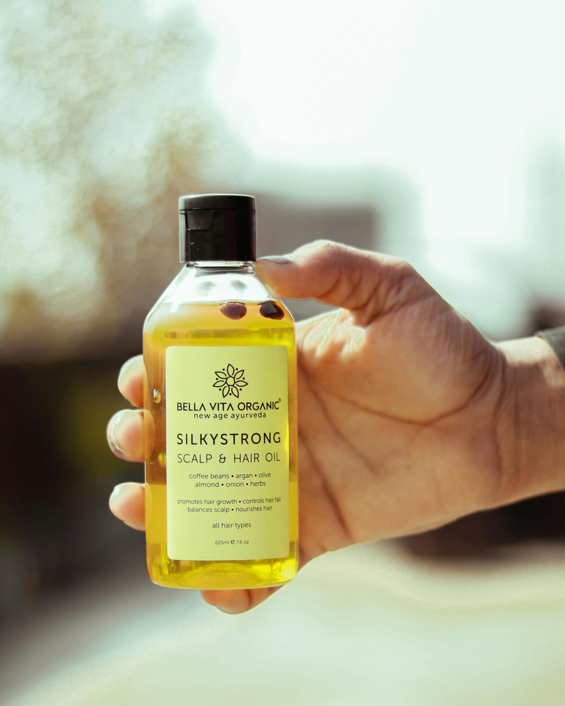 A person is holding a bottle of silkyetsoms in their hand