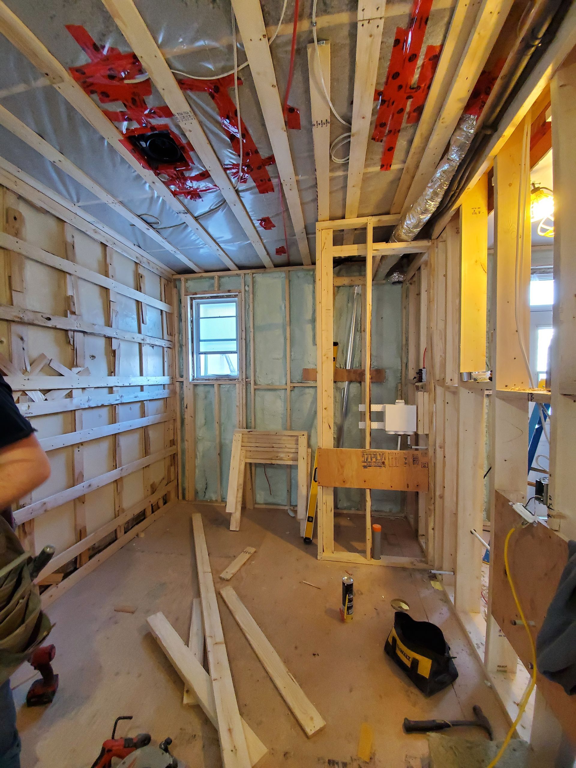 Un homme se tient dans une pièce en cours de rénovation.