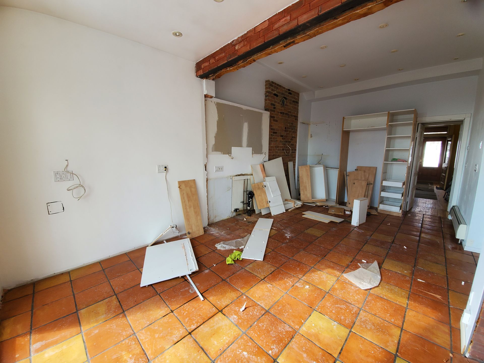 Une pièce vide avec un sol carrelé et des murs blancs.