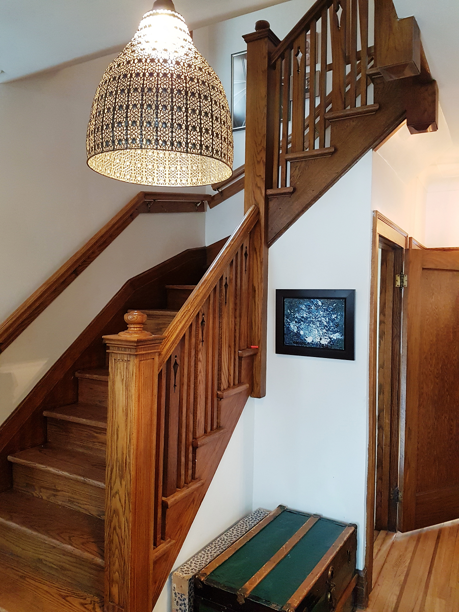 Un escalier en bois avec une photo sur le mur au-dessus