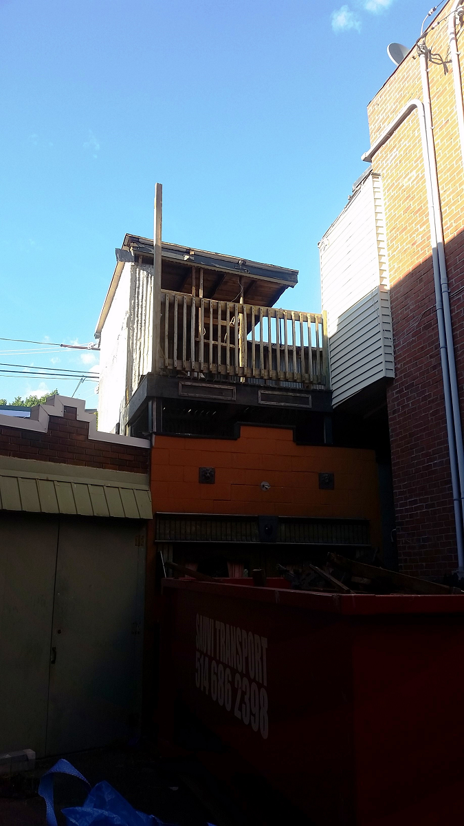 Un bâtiment avec une benne rouge devant