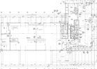 Architectural blueprint of a building floor plan with lines, text, and symbols, showing room layouts and structural details.