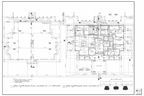Architectural blueprint of a building plan with gridlines, labeled rooms, and measurements.